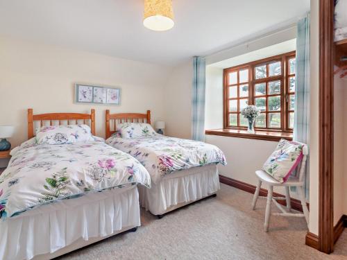 a bedroom with two beds and a window at 2 Bed in Brighstone 94031 in Brighstone