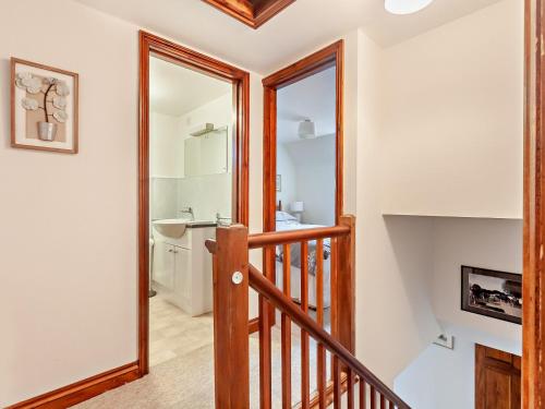 a hallway with a staircase leading to a bathroom at 2 Bed in Brighstone 94031 in Brighstone