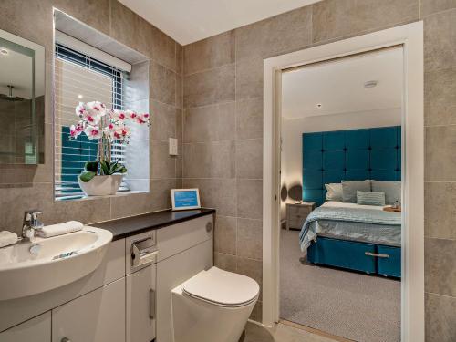uma casa de banho com um WC, um lavatório e uma cama em 2 Bed in Ticknall 93969 em Ticknall