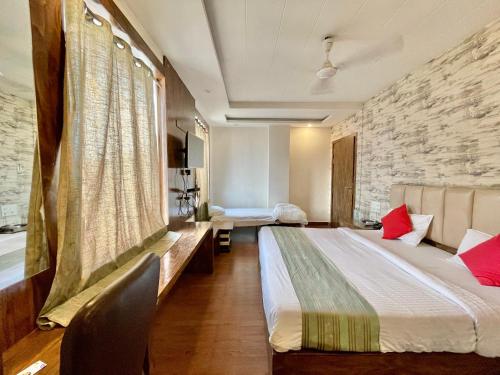 a hotel room with a bed and a stone wall at Hotel Janaki ! Varanasi ! fully-Air-Conditioned-hotel family-friendly-hotel, near-Kashi-Vishwanath-Temple and Ganga ghat in Varanasi