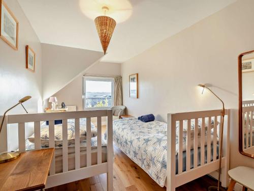 a bedroom with a bed and a desk and two lamps at 2 Bed in Haverigg 94052 in Haverigg