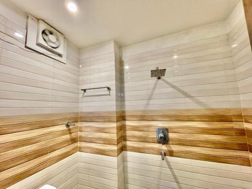 a bathroom with a shower with wooden walls at Hotel Janaki ! Varanasi ! fully-Air-Conditioned-hotel family-friendly-hotel, near-Kashi-Vishwanath-Temple and Ganga ghat in Varanasi