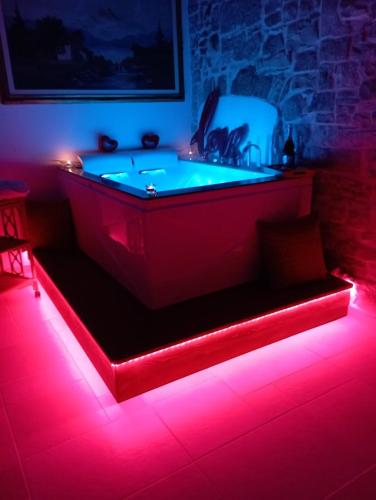 a bath tub with red lights in a room at Antico Monastero in Bitonto
