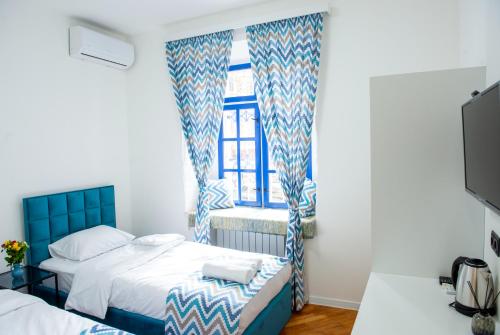 a bedroom with two beds and a window at Pallada in Yerevan