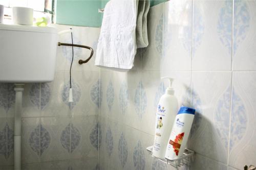 a bathroom with a bottle of lotion on the wall at Catherine home near kilimanjaro international airport JRO in Moshi