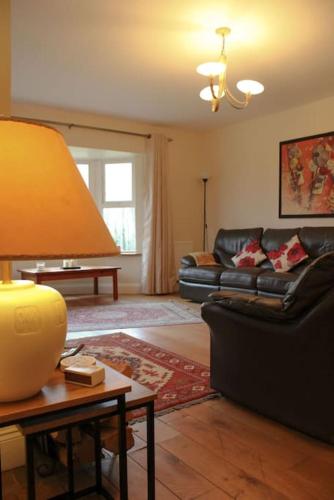 a living room with a couch and a table at The Marshes - Large home, short drive to beach in Kells