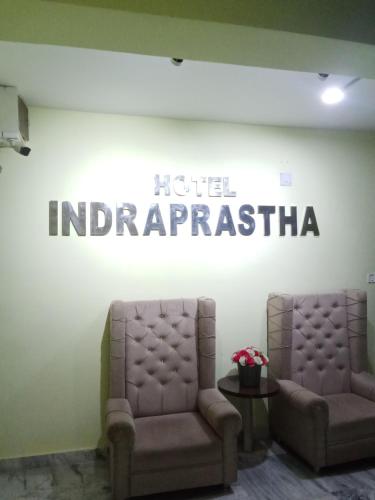 two chairs and a sign that reads hotel imperialism at Hotel Indraprastha (Dey's) in Rāiganj