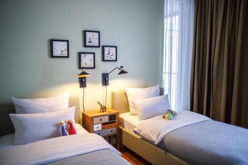 a bedroom with two beds and a window at The Circus Apartments in Berlin