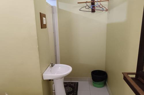 a small bathroom with a sink and a toilet at Fins Hotel, Alor Setar in Alor Setar