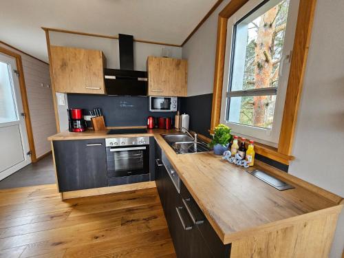a kitchen with a wooden counter top and a sink at Baumhaus und Tinyhaus in Mühlhausen