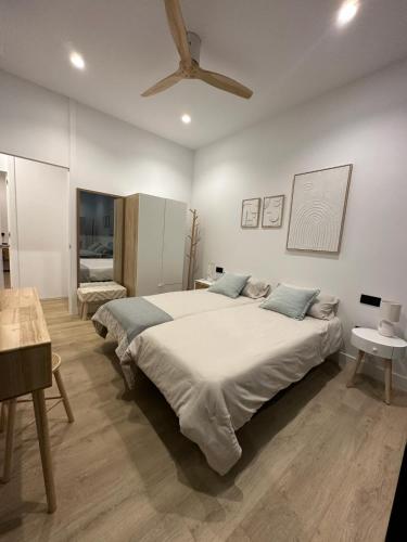 a bedroom with a large bed with a ceiling at VILLA MARIAH Barrosa Playa in Novo Sancti Petri