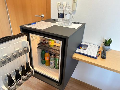 a refrigerator filled with lots of bottles and drinks at Boutique Hotel Loka in Škofja Loka