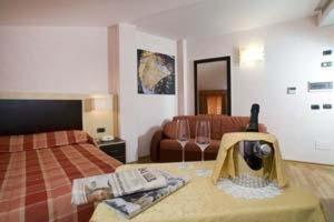 a hotel room with a bed and a camera on a table at Residenza Fontanelle in Perugia