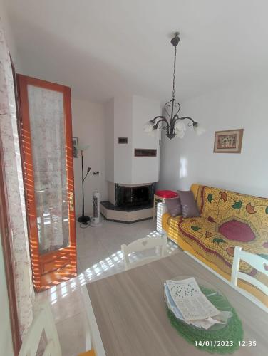 a living room with a couch and a table at La casa di Gabry in Vada