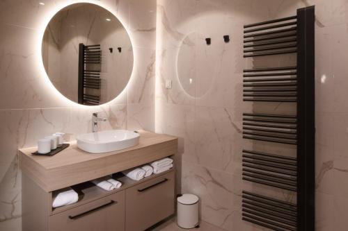 a bathroom with a sink and a mirror at HIŠA PUTR in Trzin
