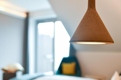 a light hanging from the ceiling of a room at Landhotel Burg im Spreewald - Resort & Spa in Burg