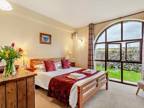 a bedroom with a bed and a large window at 2 Bed in Malham 94261 in Airton