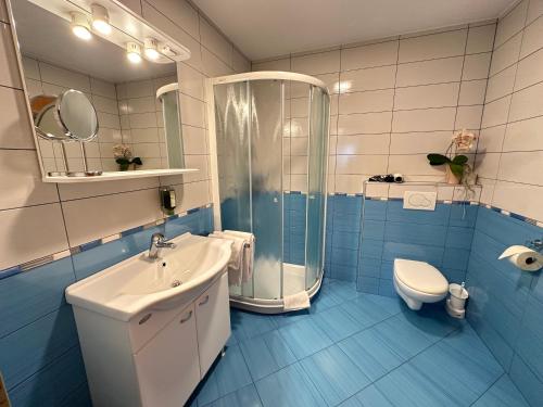 a bathroom with a sink and a shower and a toilet at Boutique Hotel Loka in Škofja Loka