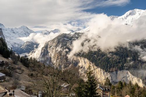 a view of a mountain with snow covered mountains at Chalet Schweizerhof Attic in Wengen