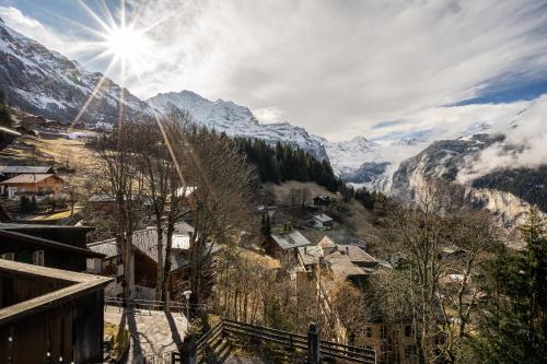 a view of a village in a mountain valley at Chalet Schweizerhof Attic in Wengen
