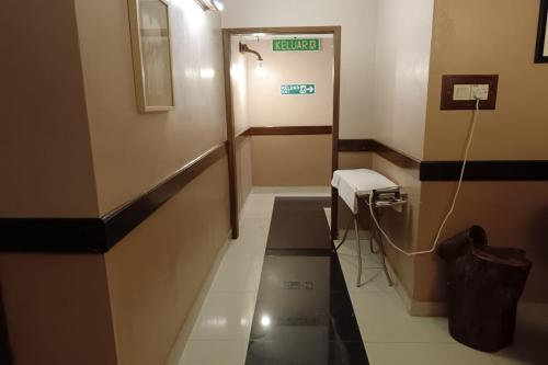 a hallway of a hospital room with a handicuggestuggest at Fins Hotel, Alor Setar in Alor Setar