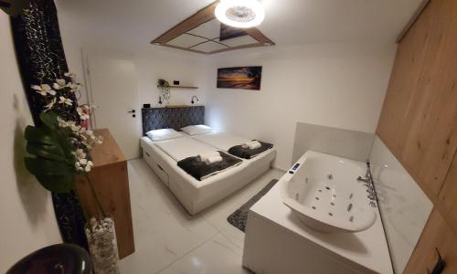 a small bathroom with a sink and a bed at Adriatic SPA Apartment in Selce