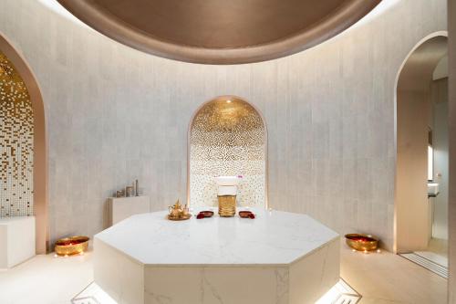 a room with a white table and a ceiling at Centara Grand At CentralWorld in Bangkok