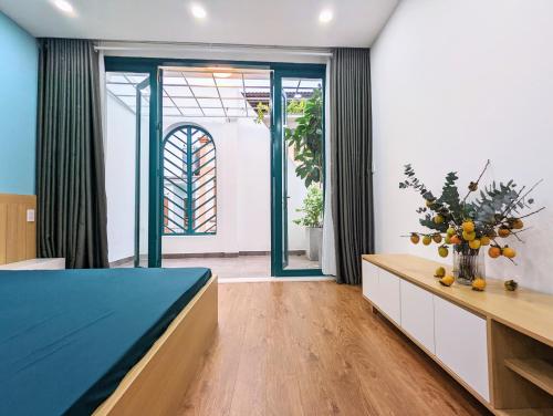 a bedroom with a bed and a table with a vase of fruit at Private Homestay District 1, Tan Ðinh Ward, HCM City in Ho Chi Minh City
