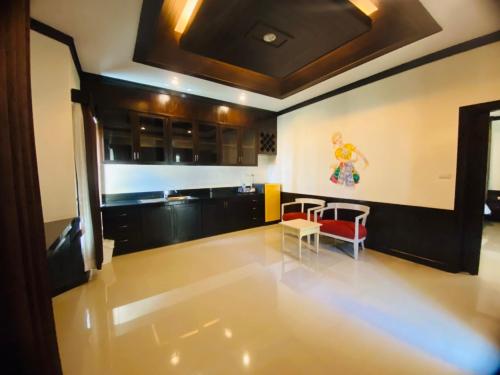 a kitchen with a table and chairs in a room at Beach Bungalow at Lanta Resort in Ko Lanta