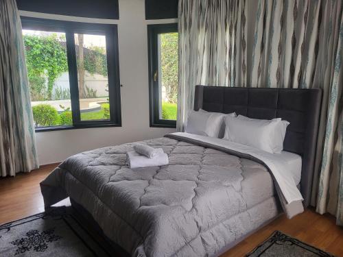 a bedroom with a large bed with a stuffed animal on it at VILLA ADAM TANGIER in Tangier