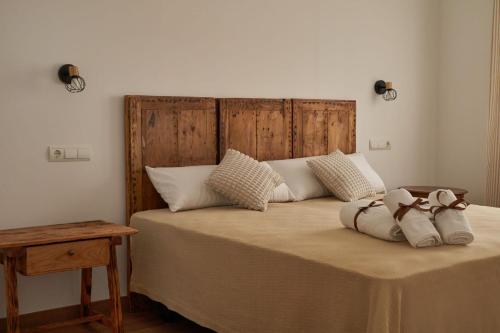 a bedroom with a large bed with two pillows at Casas Rurales El Aljibe, Jara in Argés