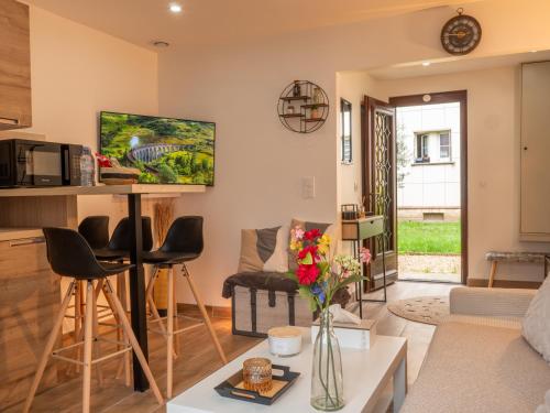 a living room with a couch and a table at Grand Studio in Le Blanc-Mesnil