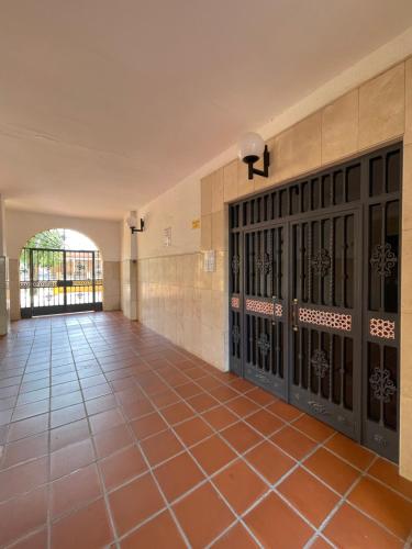 an empty hallway with doors and tile floors at Magnífico Apartamento en Sevilla in Seville