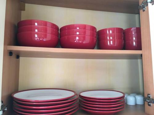 a group of red bowls sitting on a shelf at Heaste Retreat in Broadford