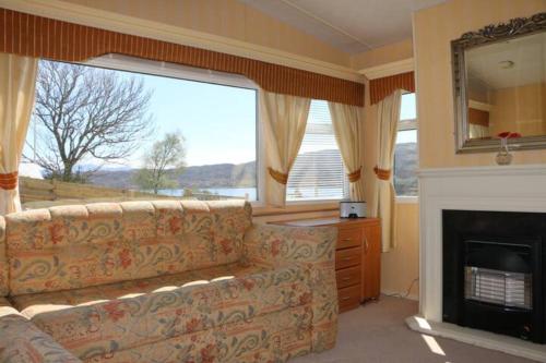 a living room with a couch and a fireplace at Heaste Retreat in Broadford