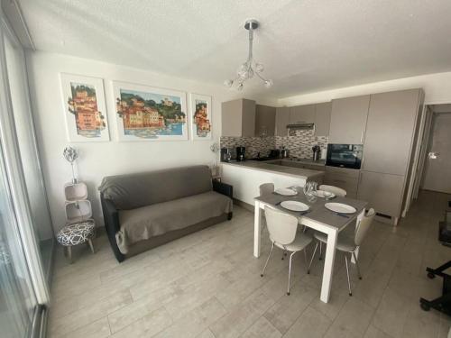ein Wohnzimmer mit einem Tisch und einem Sofa in der Unterkunft Appart rdc front de mer, calme 4MER4 in Argelès-sur-Mer