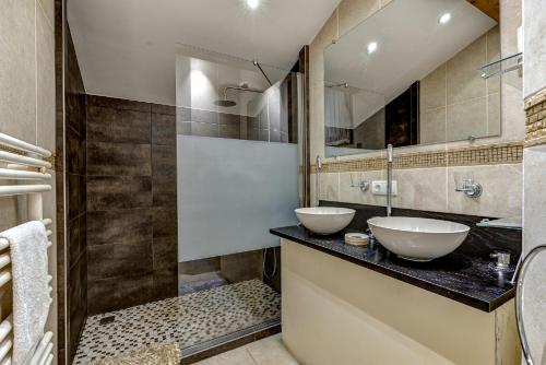 a bathroom with two sinks and a mirror at Chalet Serena - luxury 7 Bedroom Chalet, Pool & Spa in Les Houches