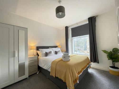 a bedroom with a bed and a large window at Skiddaw View in Keswick