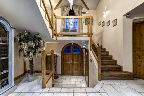 a hallway with a wooden door and stairs at Chalet Serena - luxury 7 Bedroom Chalet, Pool & Spa in Les Houches