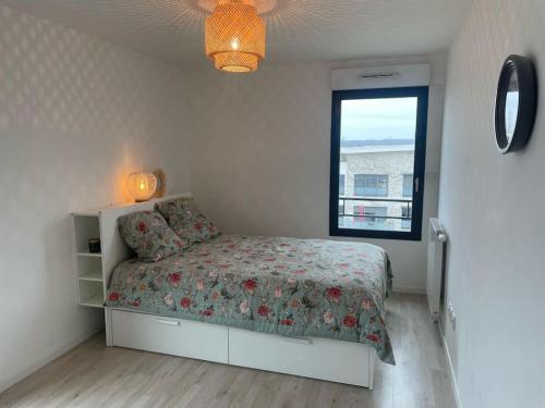 une chambre avec un lit et une fenêtre dans l'établissement Family Appartment with balcony, à Saint-Cyr-lʼÉcole