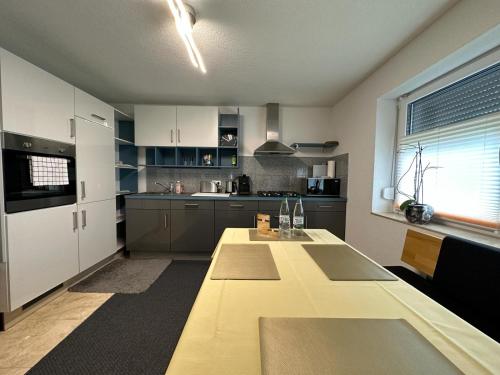 a kitchen with a large wooden table in it at Ferienhaus Federico nahe Legoland in Burgau