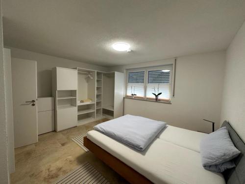 a small bedroom with a bed and a window at Ferienhaus Federico nahe Legoland in Burgau