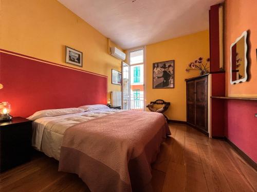 a bedroom with a large bed with a red headboard at Luxury Apartments Manarola by Arbaspàa in Manarola