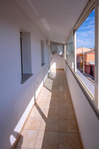 an empty corridor of a building with large windows at Sestu house in Sestu