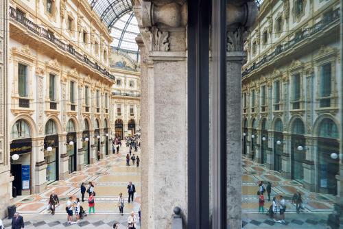 a group of people walking through a shopping mall at Park Hyatt Milano in Milan