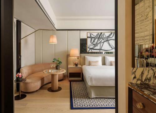 a hotel room with a bed and a couch at Park Hyatt Milano in Milan