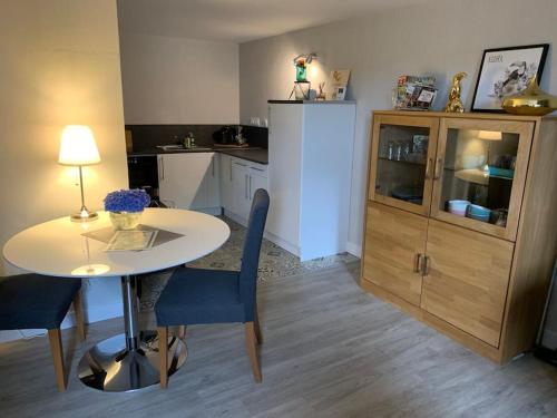 a kitchen with a table and a dining room at L’appart Quessoy in Quessoy