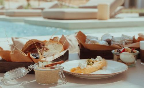 a table with a plate of food and a box of food at The Bay Hotel & Suites in Vasilikos