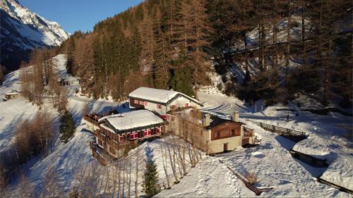 an aerial view of a house in the snow at Chalet Chez Louis - Alpine Charm with Mont Blanc View & Ski Access in Courmayeur