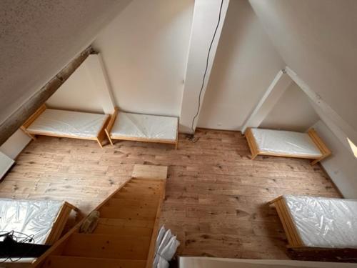 an attic room with four beds in the ceiling at private house in Ústí nad Labem